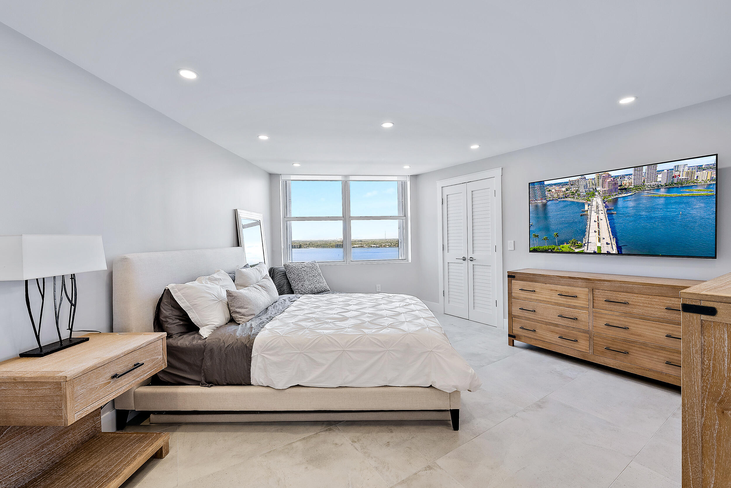 5200 North Ocean Drive, Unit 2003 Singer Island, FL 33404 - Photo 23 of 40 a bedroom with a bed and a dresser