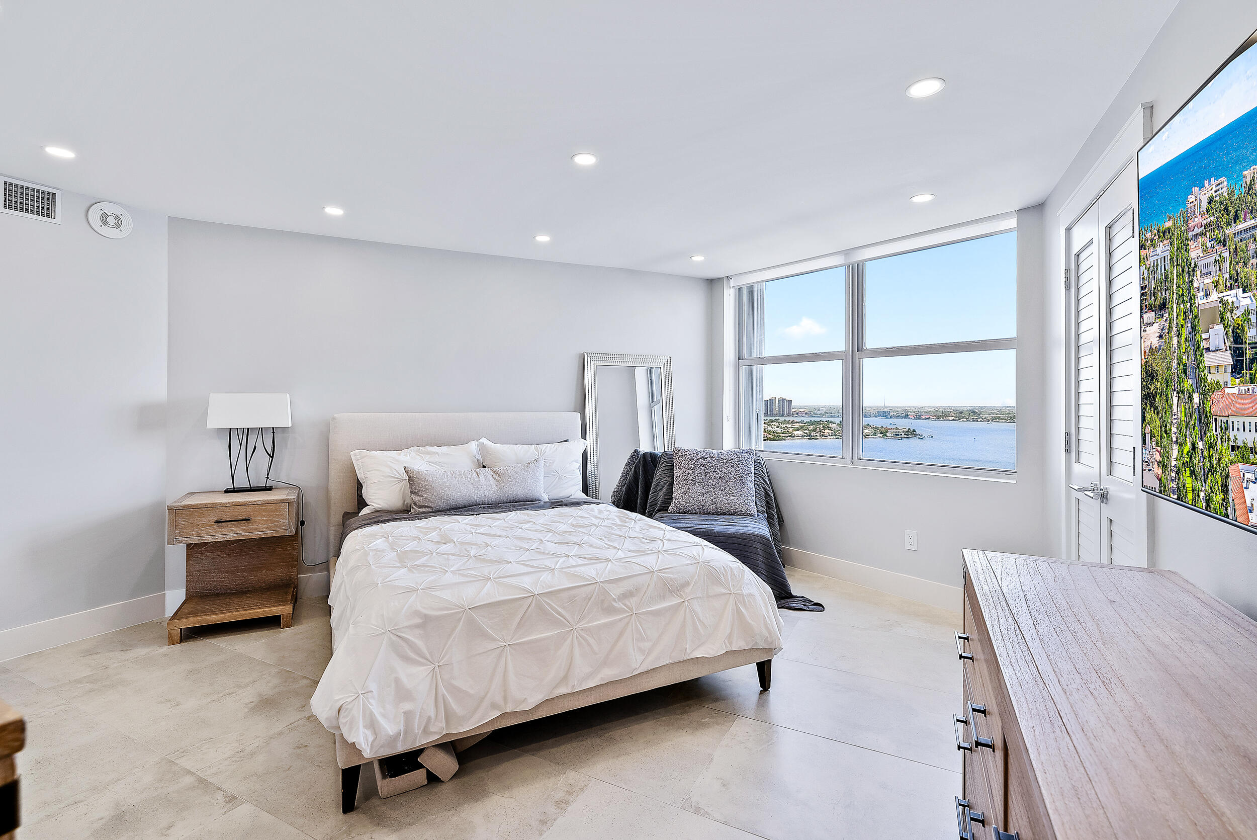 5200 North Ocean Drive, Unit 2003 Singer Island, FL 33404 - Photo 24 of 40 a bedroom with a large bed and a large window