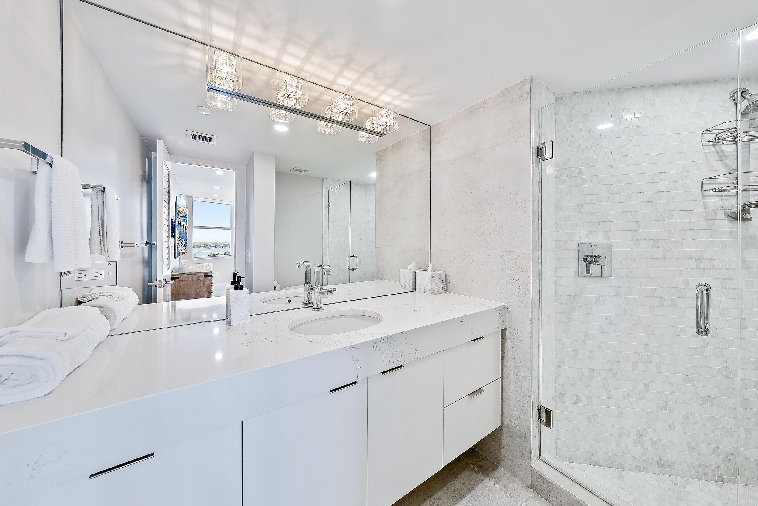 5200 North Ocean Drive, Unit 2003 Singer Island, FL 33404 - Photo 25 of 40 a bathroom with a double vanity sink mirror and shower