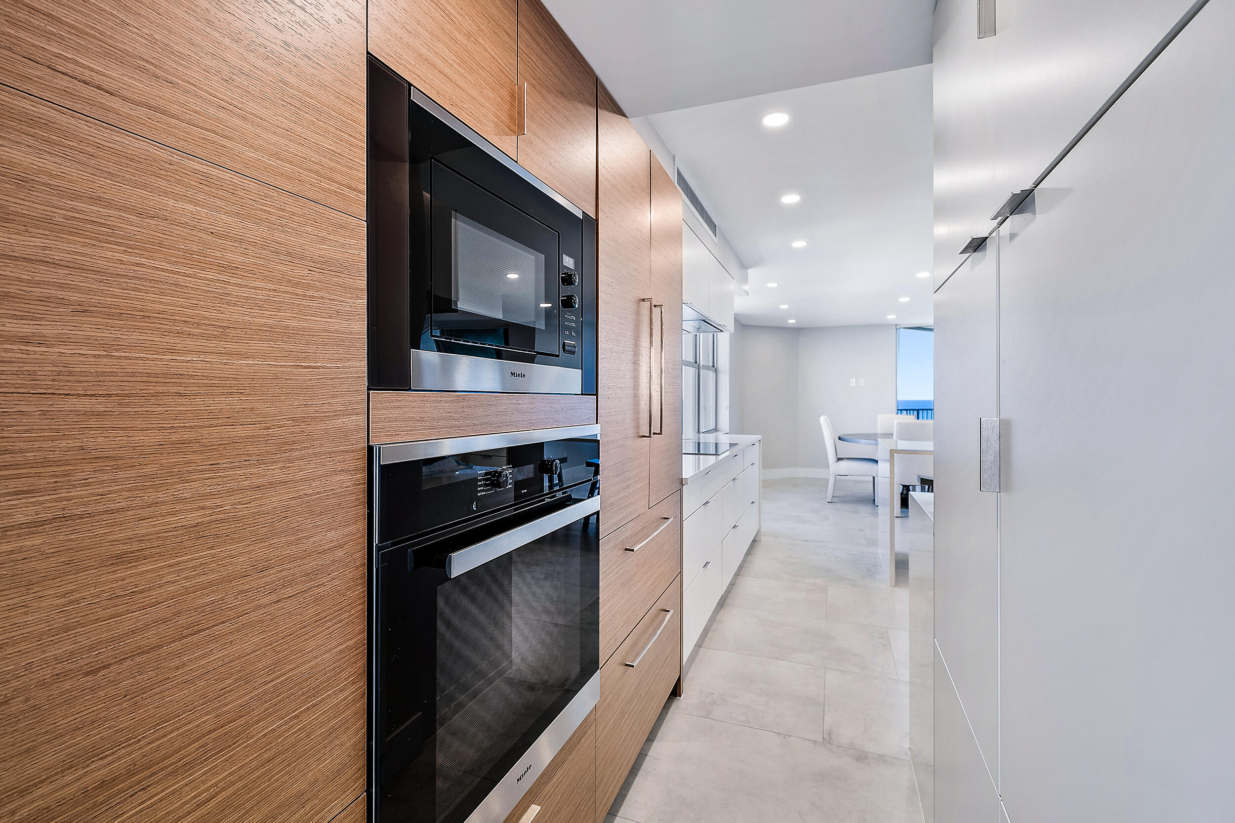 5200 North Ocean Drive, Unit 2003 Singer Island, FL 33404 - Photo 27 of 40 a hallway with a stove and a microwave