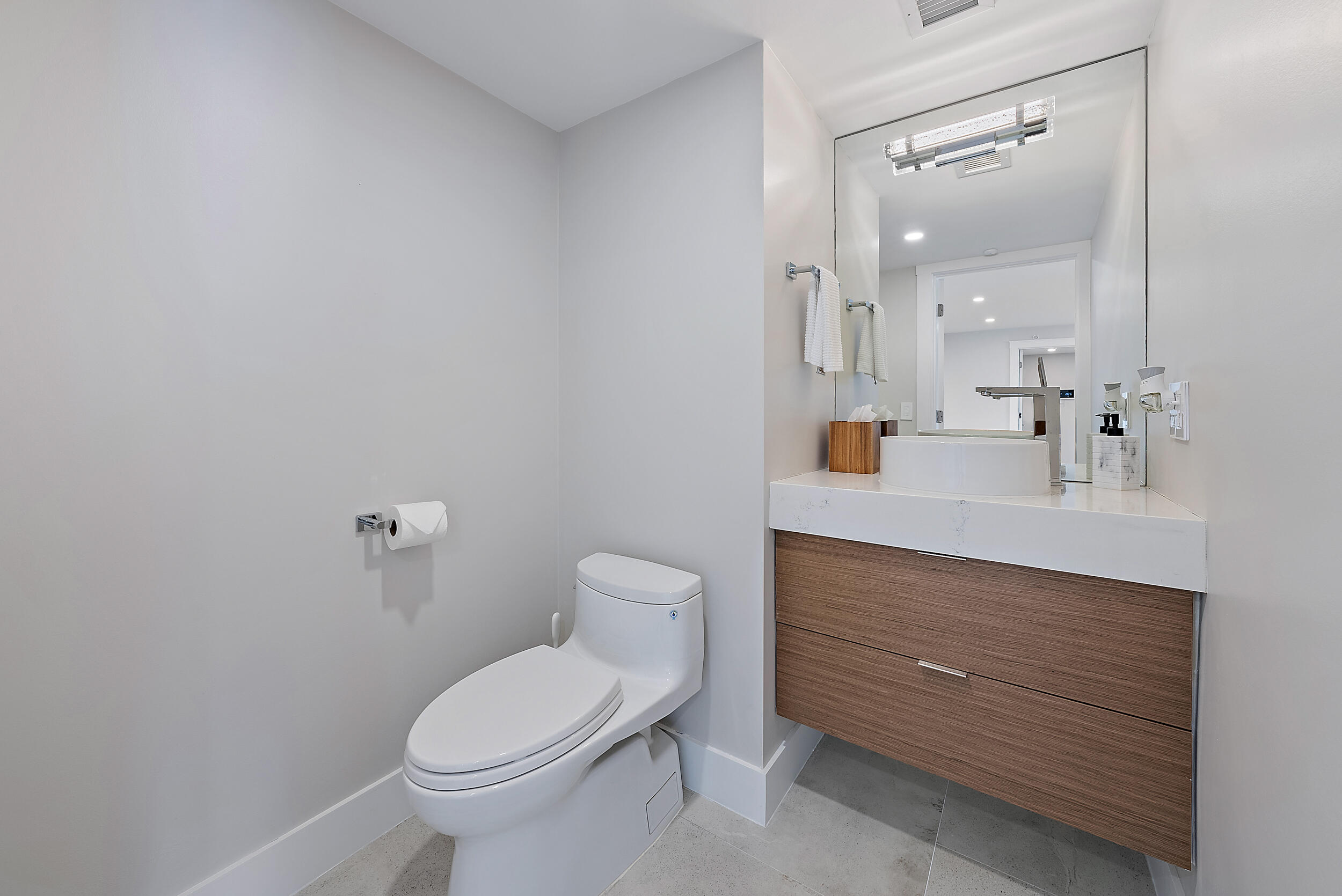 5200 North Ocean Drive, Unit 2003 Singer Island, FL 33404 - Photo 34 of 40 a bathroom with a sink vanity mirror and toilet