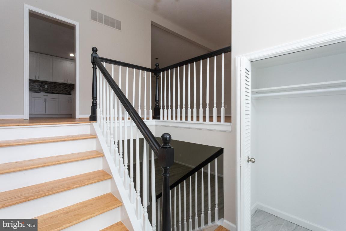 816 Hopewood Road Baltimore, MD 21208 - Photo 4 of 41 Welcoming wood stairs and a white tile foyer