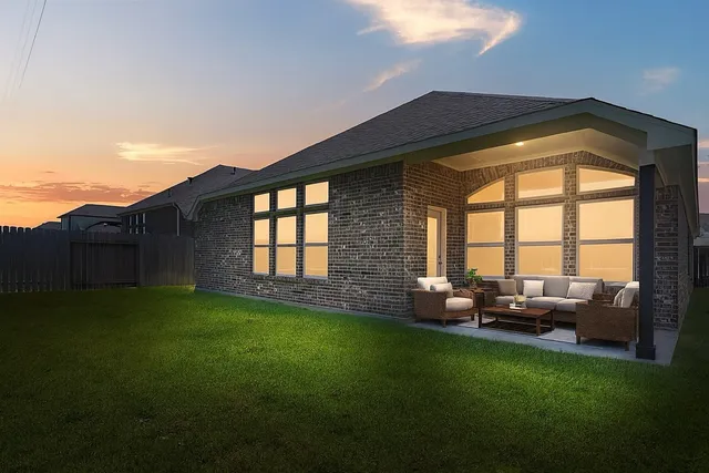 a backyard of a house with table and chairs