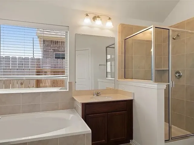 a bathroom with a bathtub and a sink