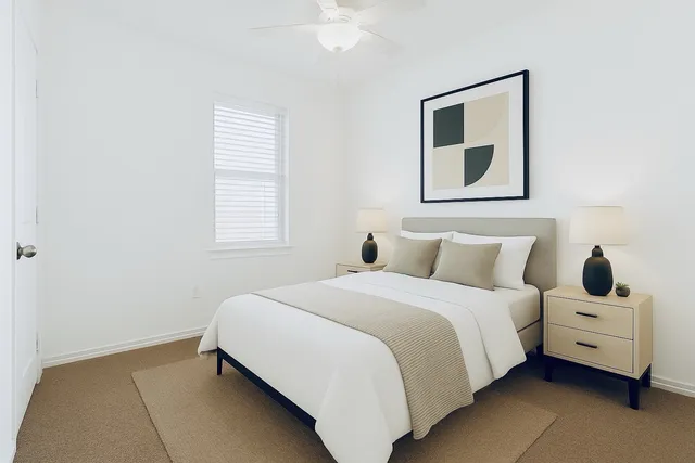 a bedroom with a bed and a window