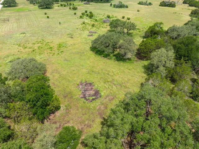 a view of a green field with wooden fence