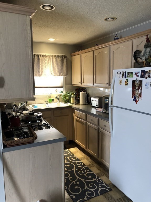 430 Hope Street Fall River, MA 02721 - Photo 6 of 28 a kitchen with a sink stove and refrigerator