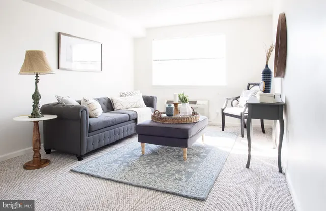 a living room with furniture and a lamp