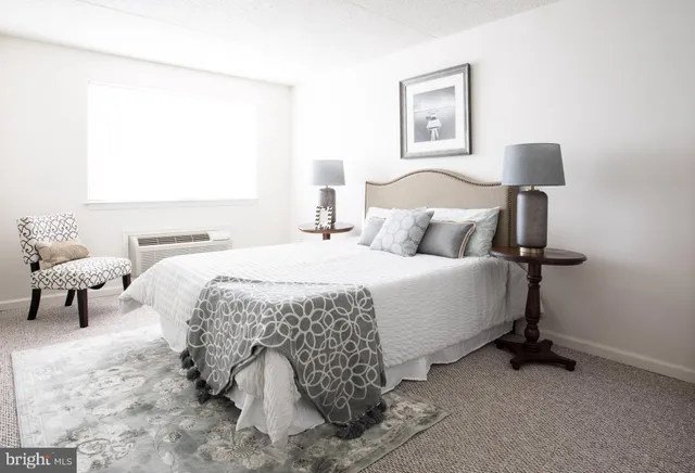 a bedroom with a bed and lamp