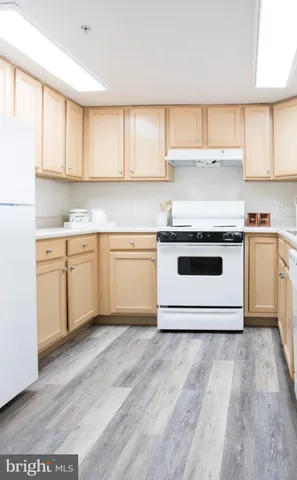 a kitchen with a stove top oven sink and cabinets