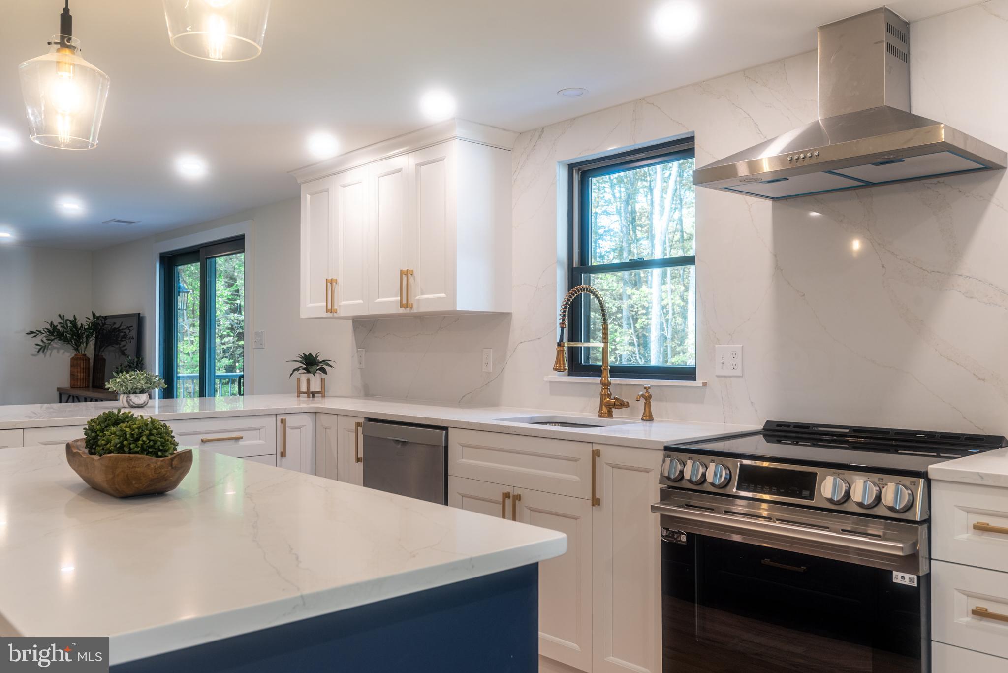 933 Forrest Road Sellersville, PA 18960 - Photo 11 of 56 a kitchen with a stove a sink and a window