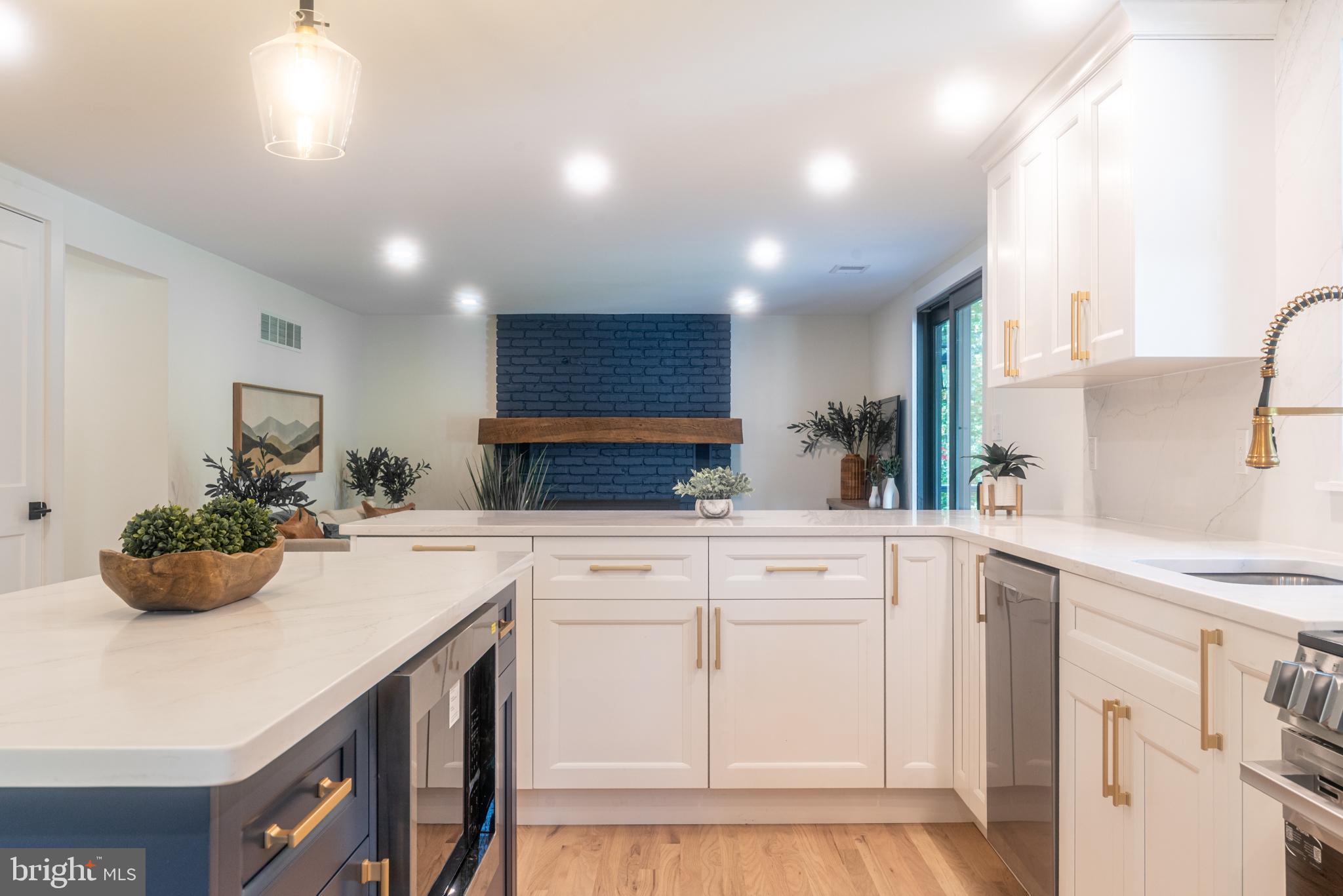 933 Forrest Road Sellersville, PA 18960 - Photo 13 of 56 a kitchen with kitchen island white cabinets and white appliances