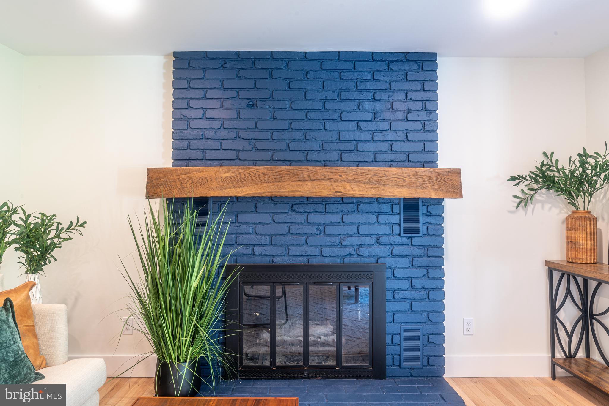 933 Forrest Road Sellersville, PA 18960 - Photo 18 of 56 a living room with a potted plant and a fireplace