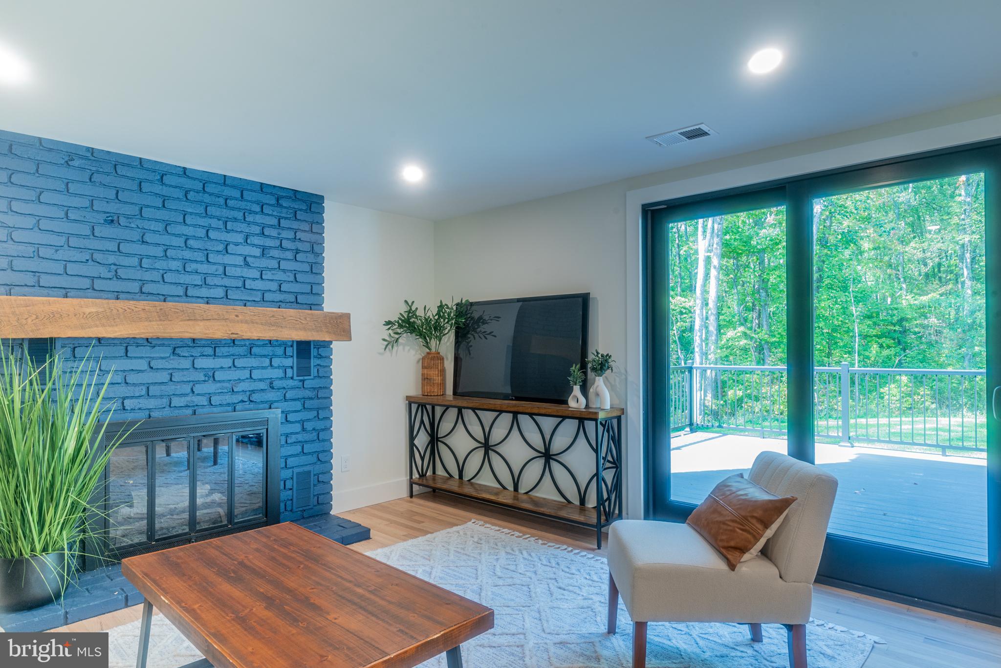 933 Forrest Road Sellersville, PA 18960 - Photo 21 of 56 a living room with furniture a flat screen tv and a fireplace