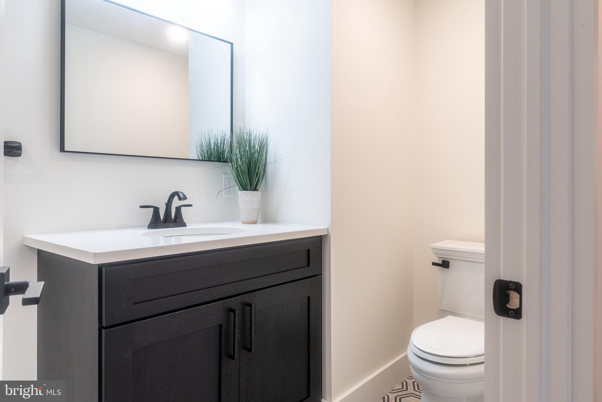 933 Forrest Road Sellersville, PA 18960 - Photo 36 of 56 a bathroom with a sink a toilet and mirror