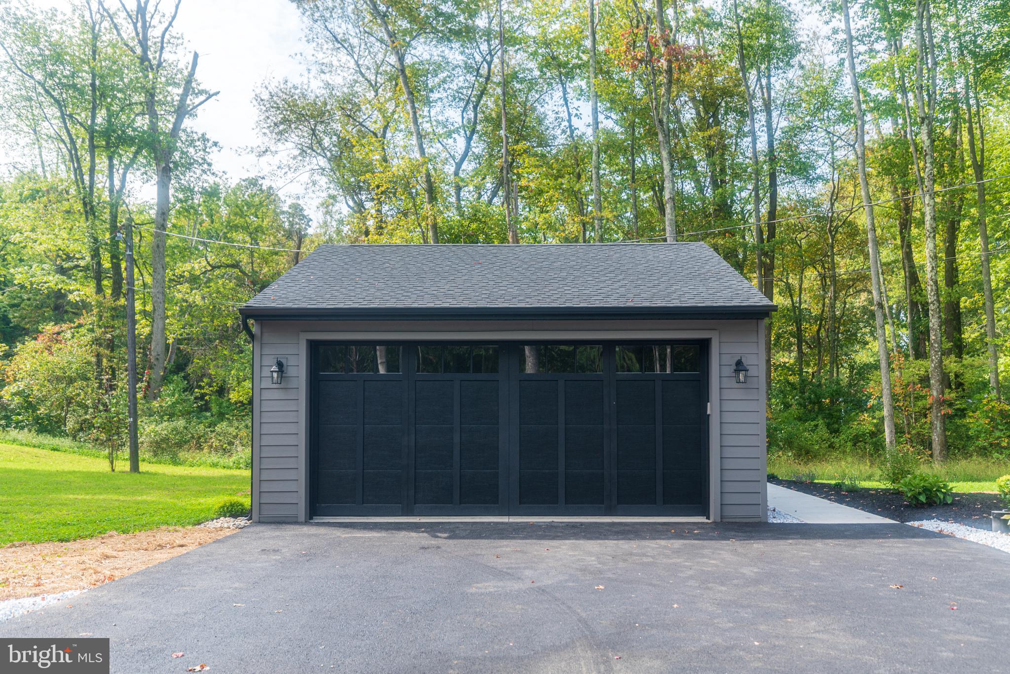 933 Forrest Road Sellersville, PA 18960 - Photo 5 of 56 a front view of a house with a yard and garage
