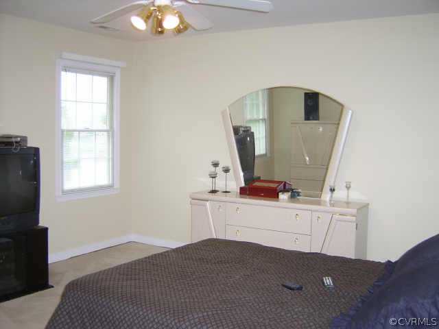 11630 Stephens Point Drive Chester, VA 23831 - Photo 6 of 10 a living room with a bed furniture and a window