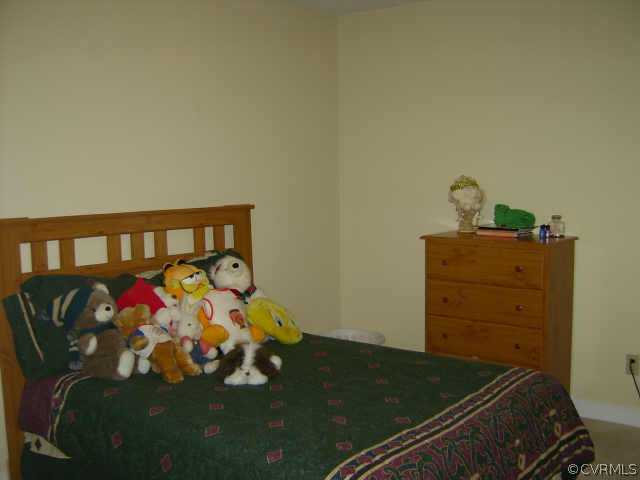 11630 Stephens Point Drive Chester, VA 23831 - Photo 7 of 10 a bed sitting in a bedroom next to a window
