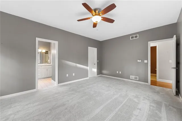 a view of an empty room with a ceiling fan