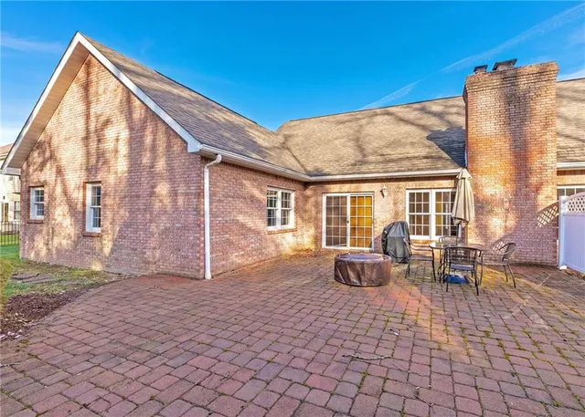 a backyard of a house with outdoor seating