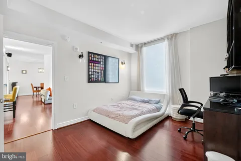 a bedroom with a bed furniture and a flat screen tv