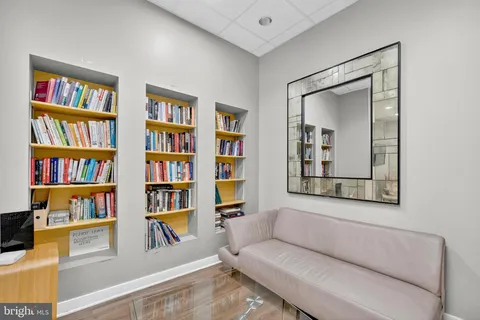 a living room with couch and a book shelf