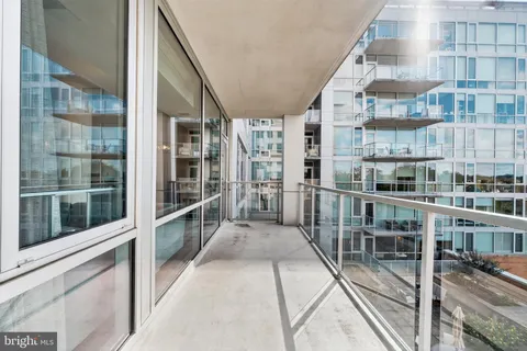 a view of a balcony with a floor to ceiling window and stairs
