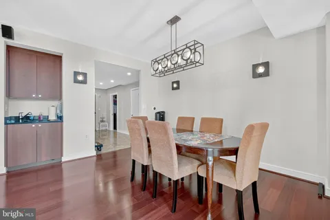 a view of a dining room with furniture wooden floor and a chandelier