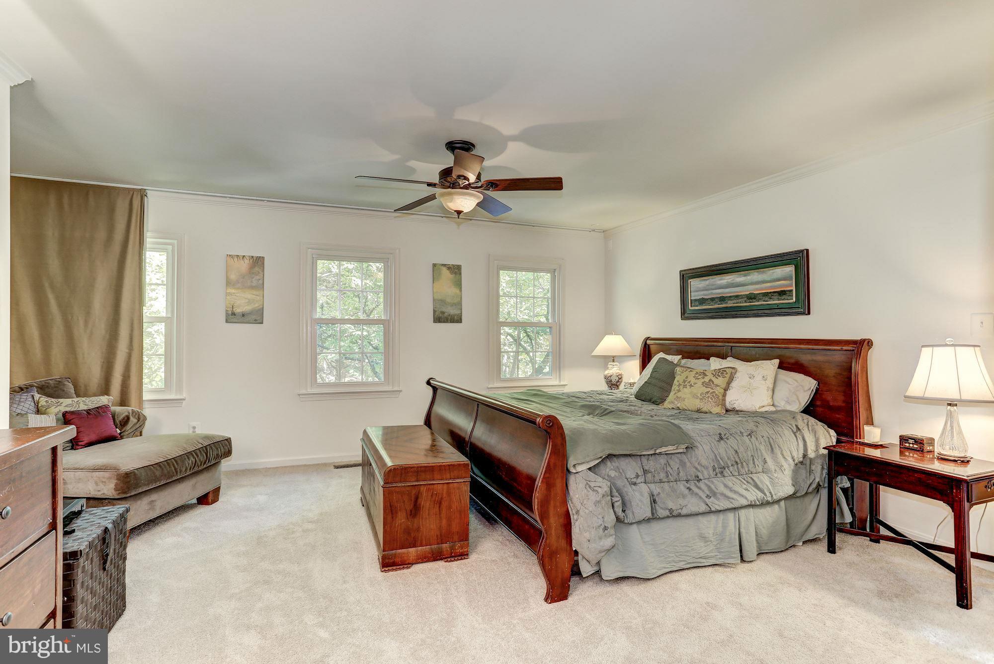 2232 Wakerobin Lane Reston, VA 20191 - Photo 15 of 30 a bedroom with a bed and a chandelier