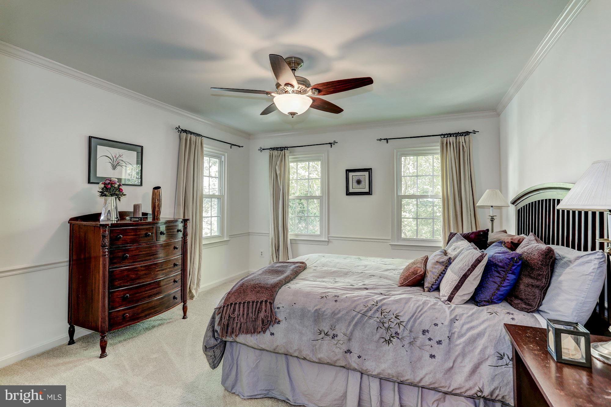 2232 Wakerobin Lane Reston, VA 20191 - Photo 19 of 30 a bedroom with a bed and a chandelier