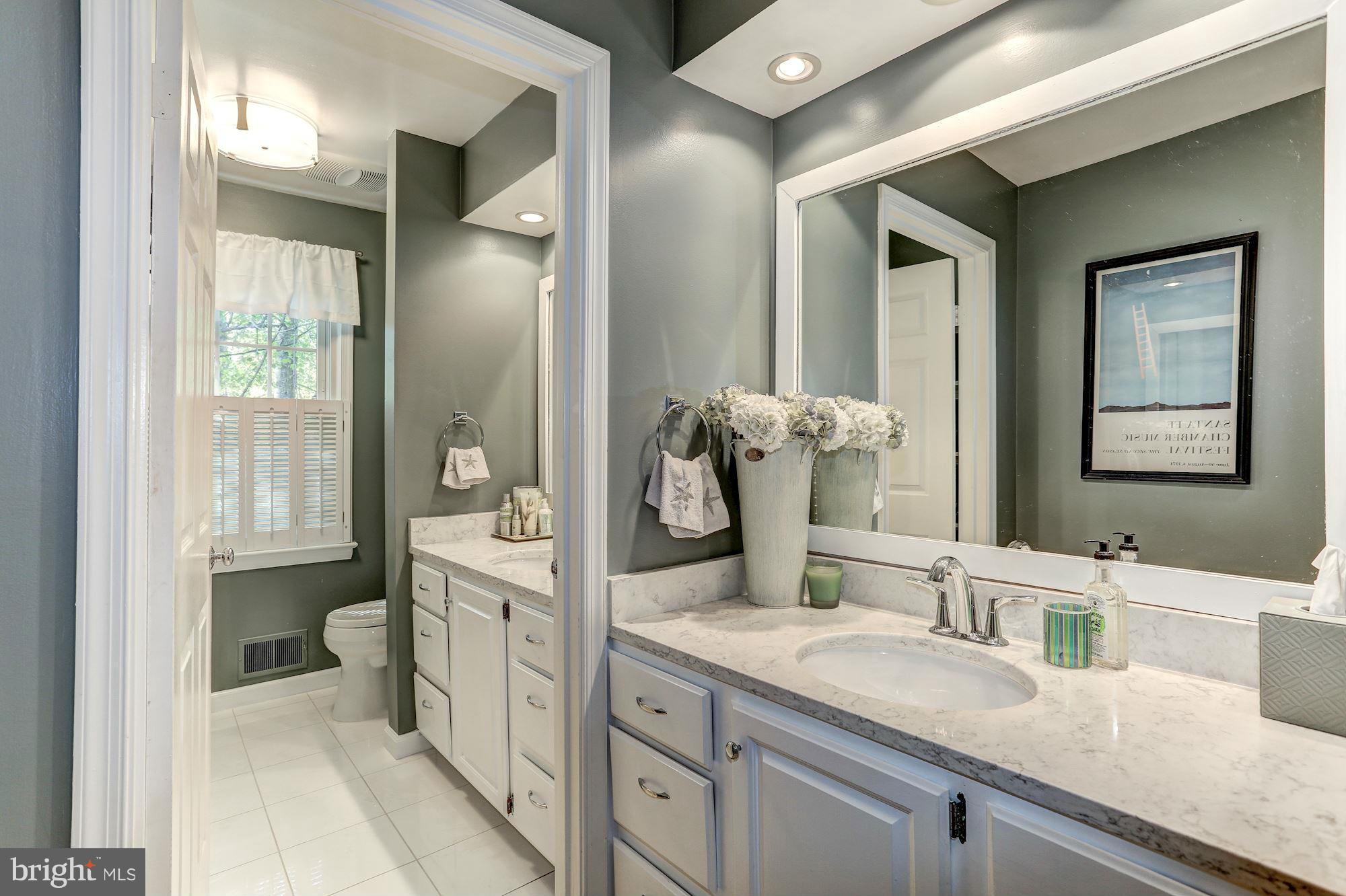 2232 Wakerobin Lane Reston, VA 20191 - Photo 20 of 30 a spacious bathroom with a granite countertop sink and a mirror