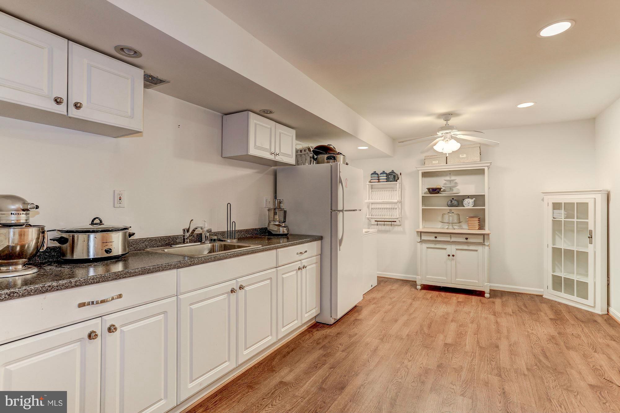 2232 Wakerobin Lane Reston, VA 20191 - Photo 23 of 30 a kitchen with granite countertop white cabinets and white appliances