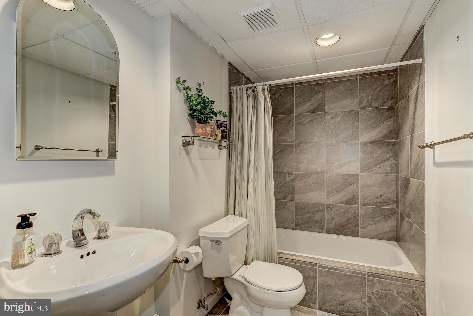 2232 Wakerobin Lane Reston, VA 20191 - Photo 24 of 30 a bathroom with a sink mirror and toilet