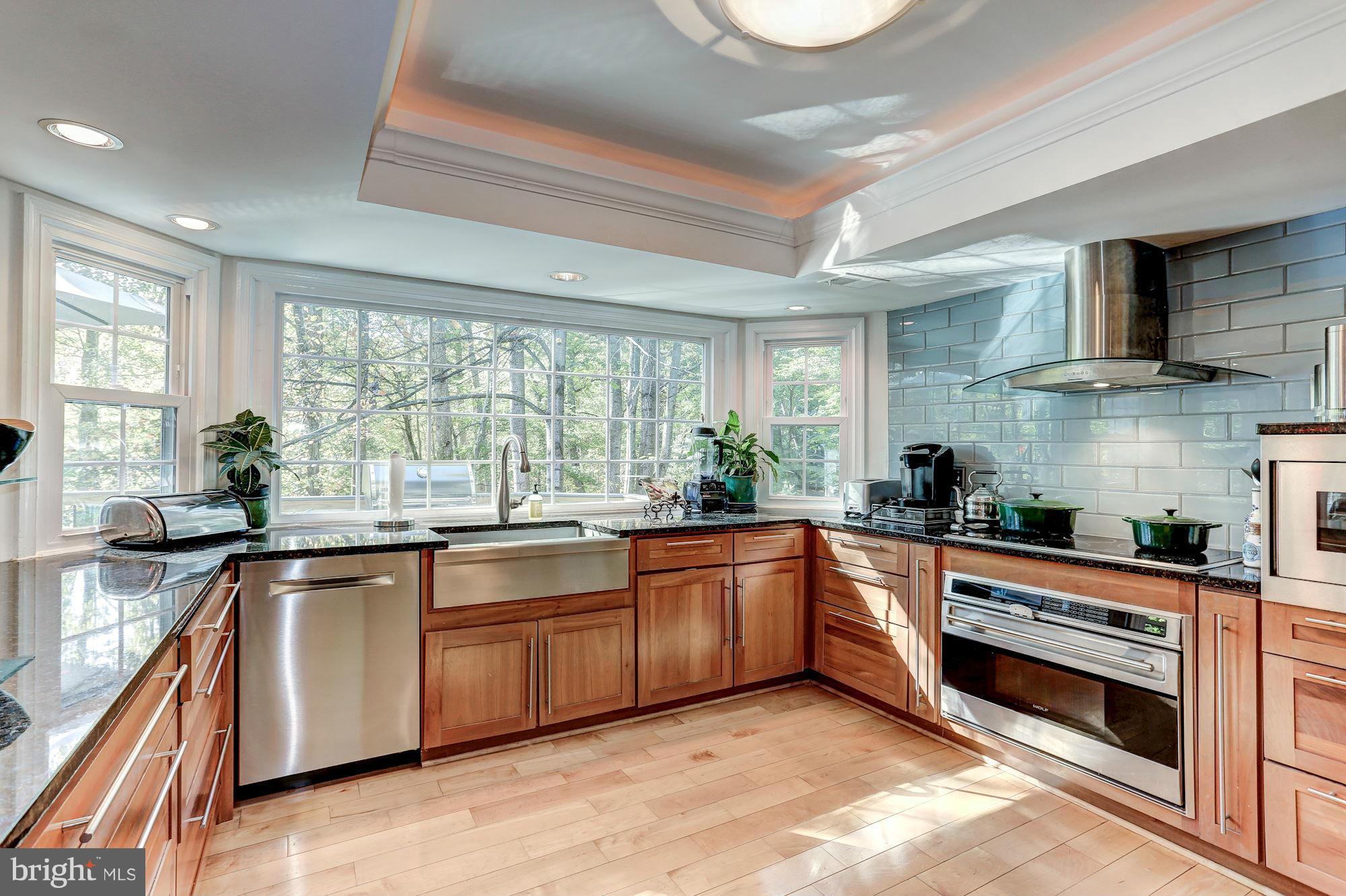 2232 Wakerobin Lane Reston, VA 20191 - Photo 4 of 30 a kitchen with stainless steel appliances granite countertop hardwood floor sink stove and granite counter top