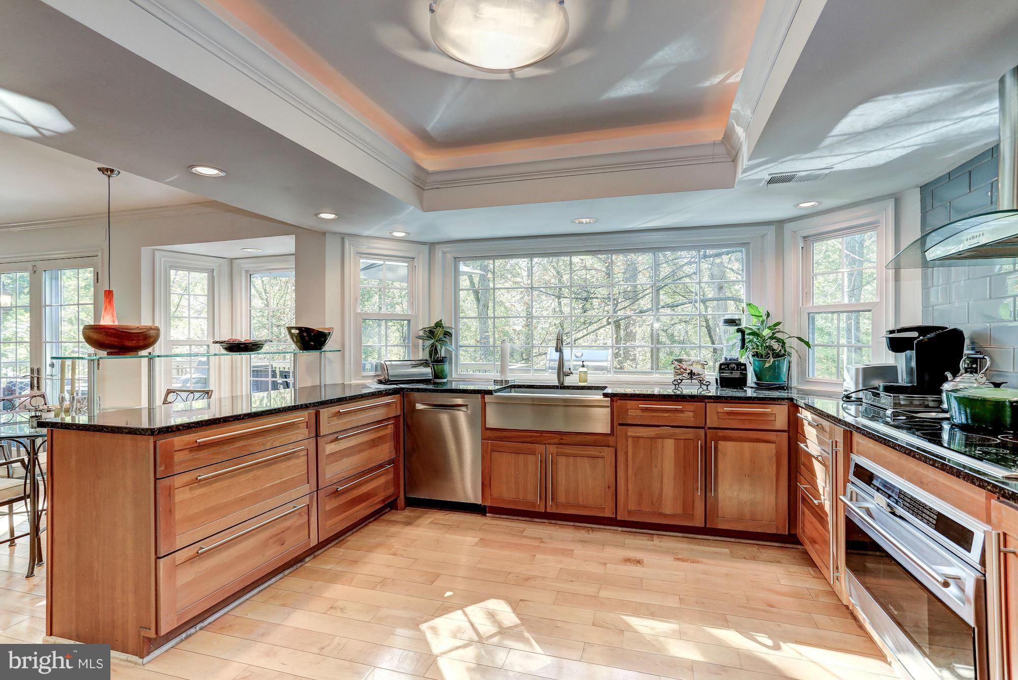 2232 Wakerobin Lane Reston, VA 20191 - Photo 6 of 30 a large kitchen with stainless steel appliances granite countertop a stove and cabinets