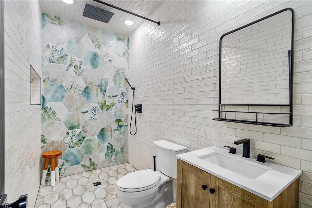 9346 Homestead Lane Forney, TX 75126 - Photo 30 of 39 This full bathroom is located downstairs in the barndo/shop and features beautiful tile and modern fixtures.
