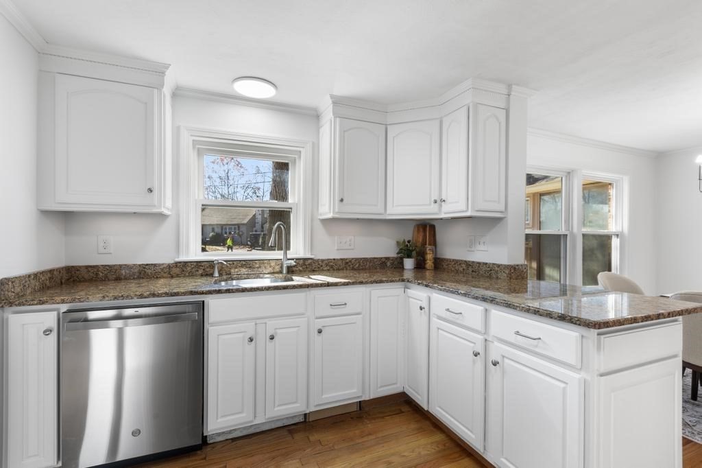 51 Himoor Circle Randolph, MA 02368 - Photo 14 of 29 a kitchen with granite countertop white cabinets white appliances and sink