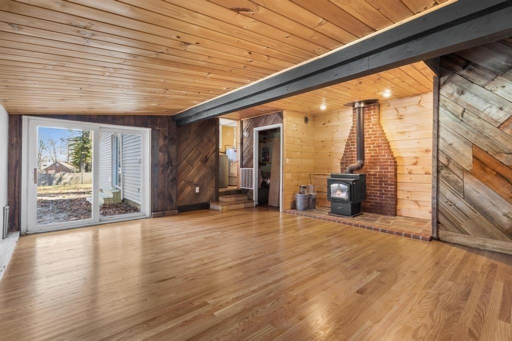 51 Himoor Circle Randolph, MA 02368 - Photo 19 of 29 an empty room with wooden floor and windows