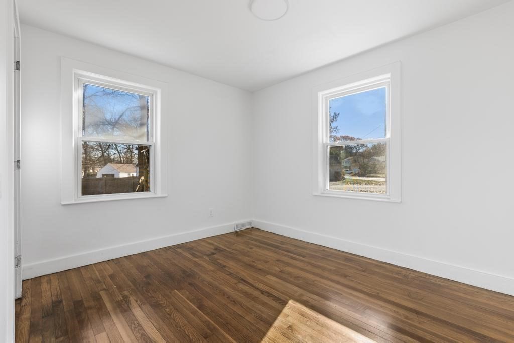 51 Himoor Circle Randolph, MA 02368 - Photo 22 of 29 a view of an empty room with wooden floor and a window