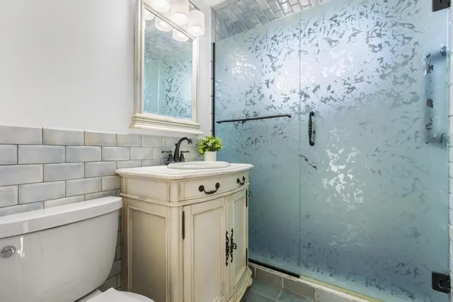 a bathroom with a sink toilet and shower