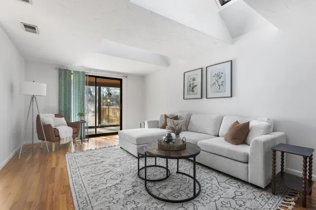 a living room with furniture and wooden floor