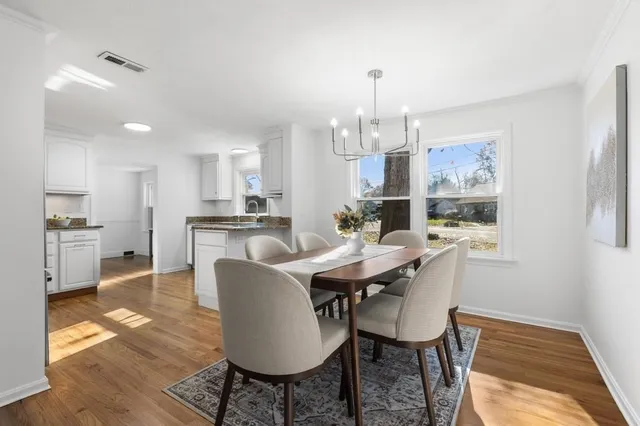 a view of a dining room with furniture and wooden floor