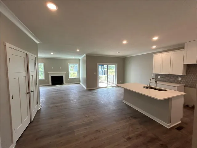 a view of a kitchen with a sink and a refrigerator