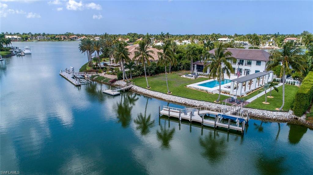 3595 Gin Lane Naples, FL 34102 - Photo 1 of 31 a view of a lake with houses