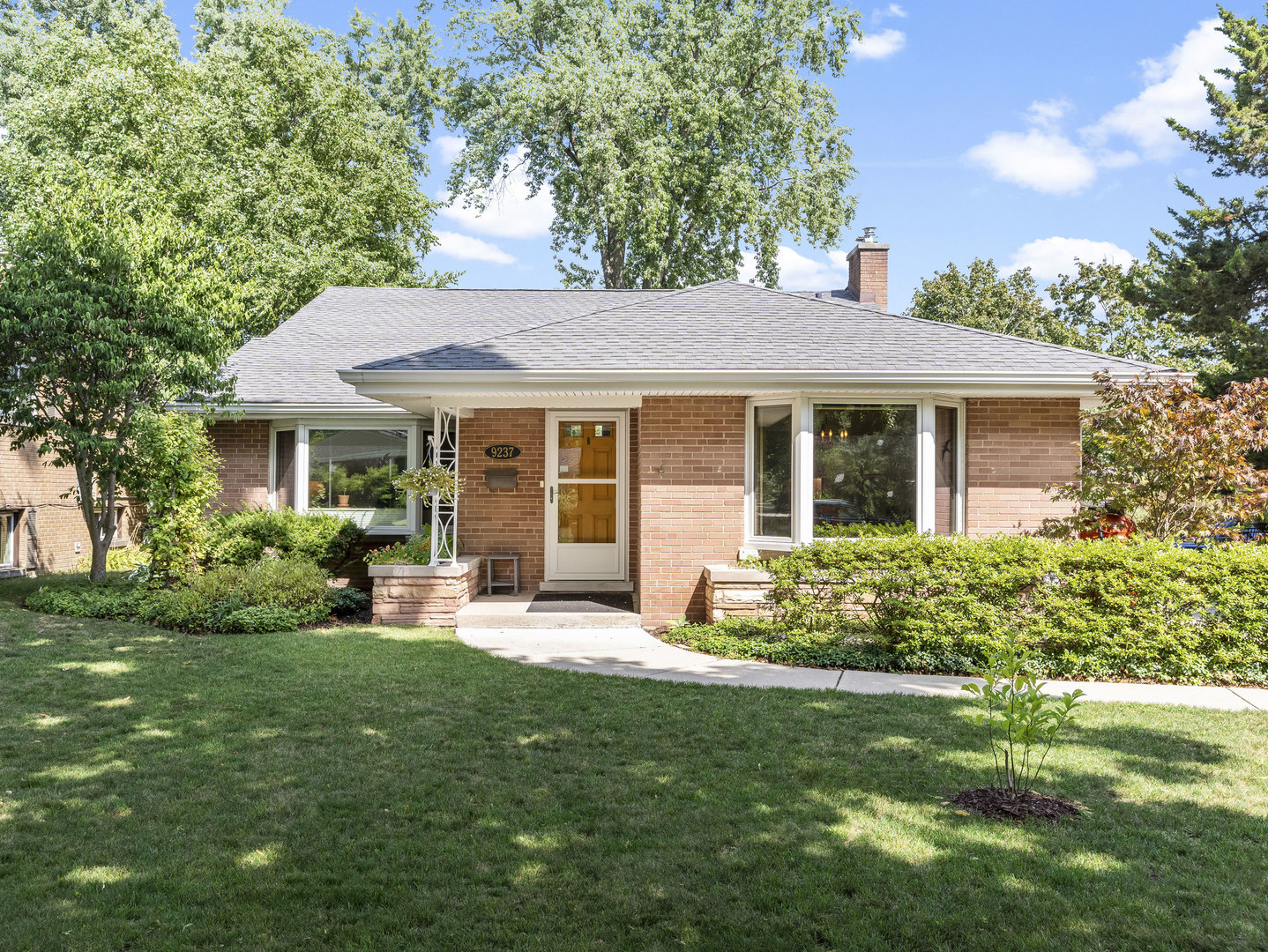 a front view of house with yard and green space