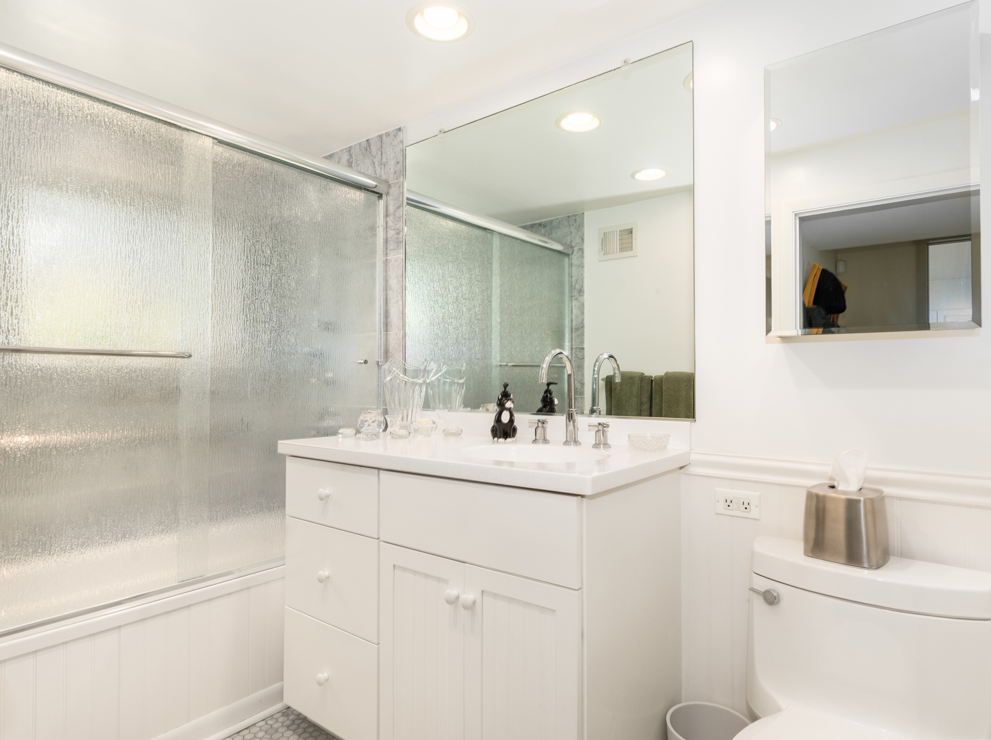 9237 Forestview Road Evanston, IL 60203 - Photo 18 of 33 a bathroom with a sink and mirror with toilet