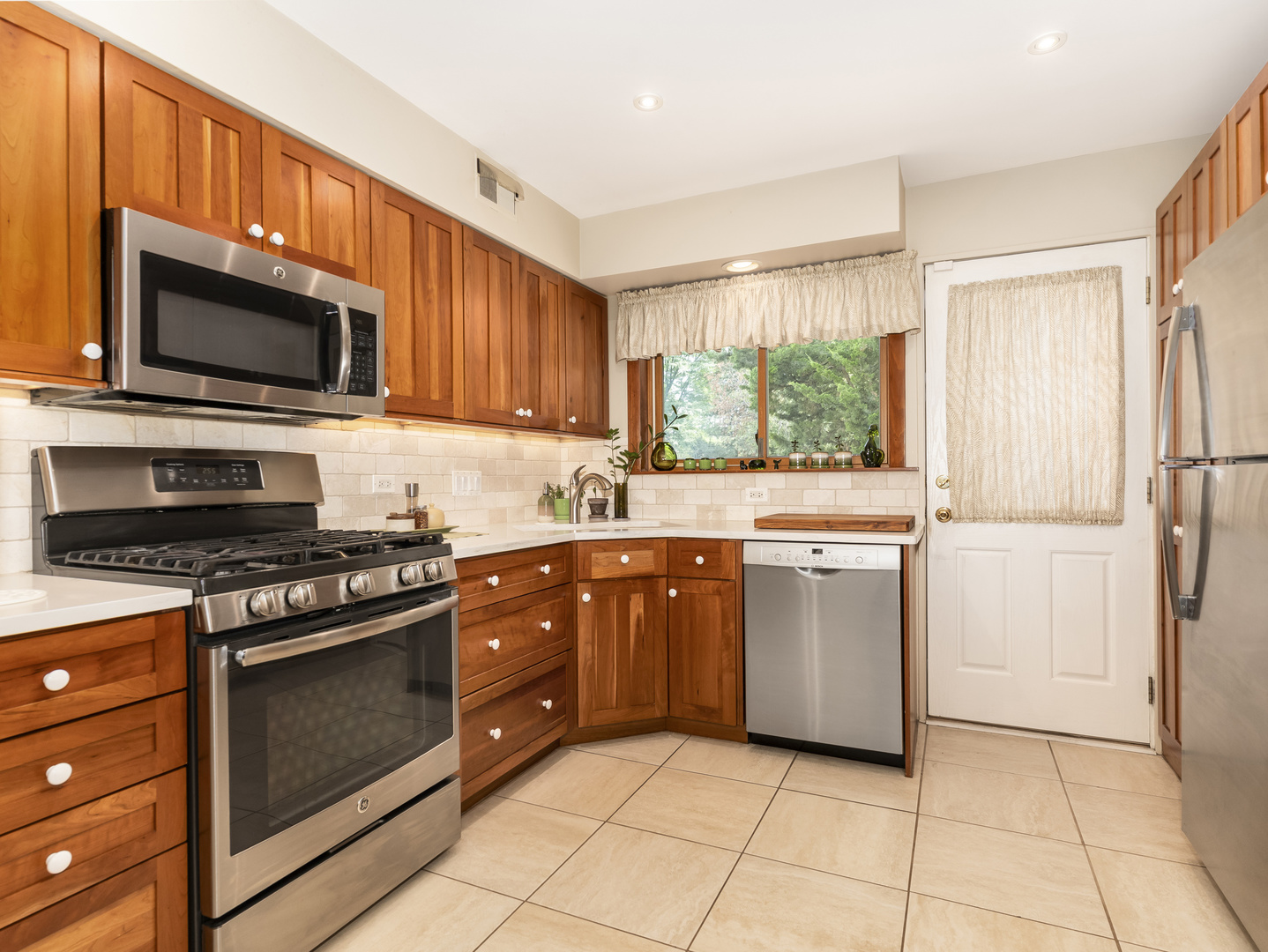 9237 Forestview Road Evanston, IL 60203 - Photo 9 of 33 a kitchen with a stove microwave and sink
