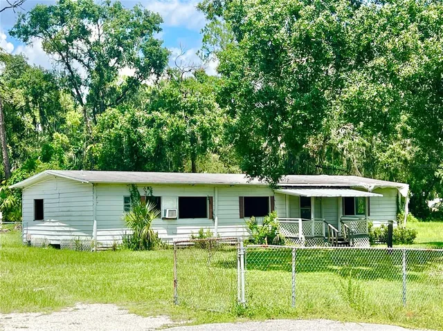 a front view of a house with a yard table and chairs