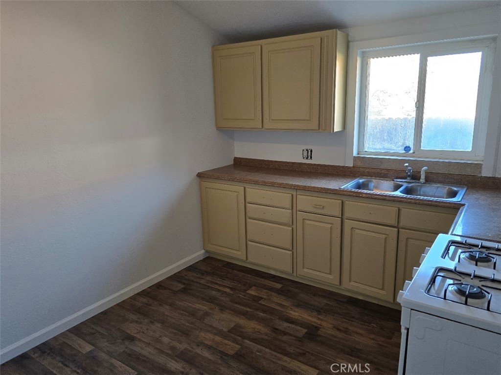3470 Point Sal Road Casmalia, CA 93429 - Photo 12 of 17 a room with wooden cabinets washer dryer and a sink