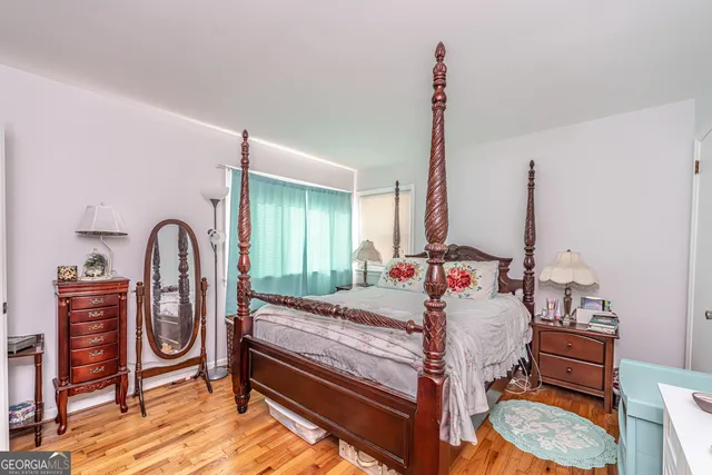 a bedroom with furniture and a wooden floor